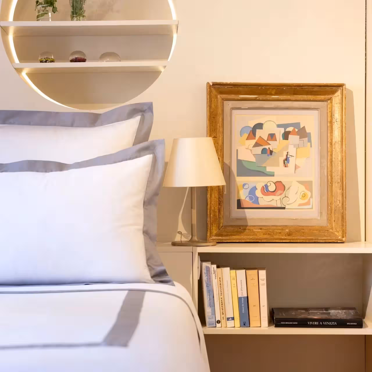 Bett mit weißen Kissen neben Nachtschrank