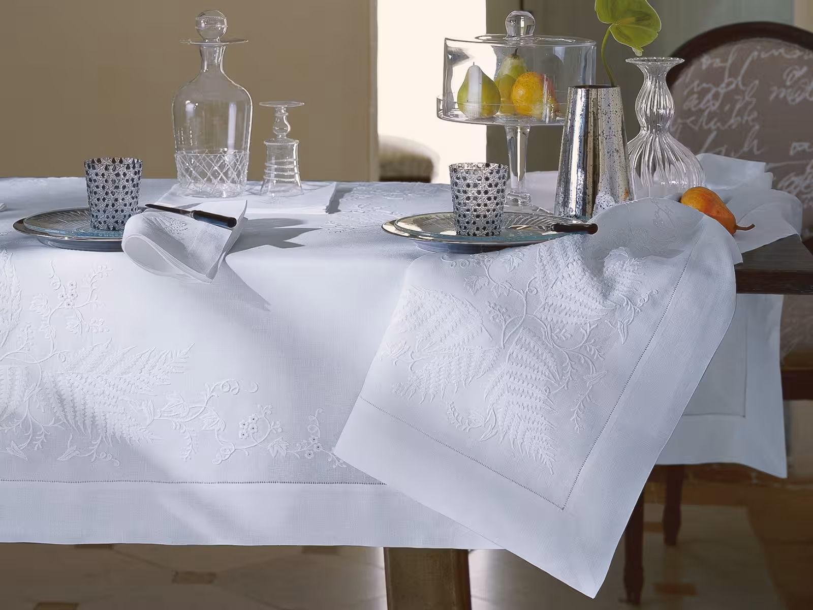 Tisch mit Gläsern und weißer Tischdecke